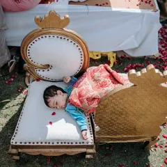 Sometimes, a long wedding day is just too much for the little ones. This adorable shot of a child napping on a chair amidst the festivities is a real and heartwarming moment.