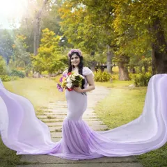 For this outdoor maternity shoot, I created a soft, ethereal look. The makeup is minimal and fresh to enhance her natural glow, paired with gentle waves and a flower crown to match the dreamy lavender gown.