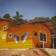 We gave this beautiful homestay in Sakleshpur a signature photo spot with these colorful wings. The art pops against the building's bright exterior and the natural scenery, making it an irresistible spot for guest photos.