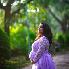 A serene moment during a maternity shoot. The soft lighting highlights her pregnancy glow, which I enhanced with a natural and radiant makeup application.