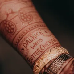 A close-up of the "Dalrice weds Butterchicken" hashtag after the henna stain has fully developed. It's a beautiful and lasting reminder of their unique story.