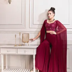 A great example of modern Indian wedding fashion for a Sangeet or cocktail event. I styled this deep maroon sharara set with dramatic cape sleeves and an embellished crop top for a chic, contemporary bride.
