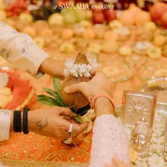 A close-up of the couple's hands during a puja, holding a sacred coconut. I focus on capturing these meaningful details that are central to the Hindu wedding ceremony.