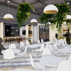 The canteen at Jaipuria Institute of Management, Jaipur, is designed as a vibrant hub for students. The space features modern furniture, a chalkboard wall, and lush hanging greenery, creating a perfect balance of functionality and aesthetics.