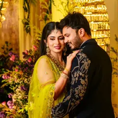 A beautiful moment between a couple at their celebration. Her lime green embroidered lehenga and his navy embroidered sherwani are a perfect example of how I coordinate outfits for the bride and groom.