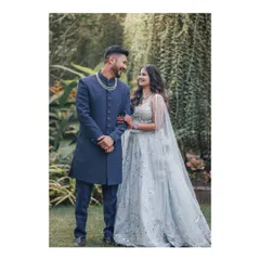 A look of pure adoration. This engagement portrait, set in a lush garden, captures the couple looking at each other with all the love and excitement for their future.