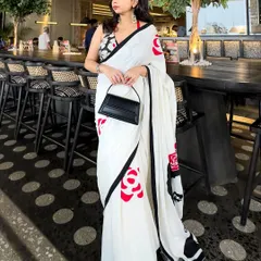 A modern saree look perfect for a special date night or a chic lunch. I believe in creating outfits that are memorable, combining unique pieces like this hand-painted saree with a contemporary halter-neck blouse and a structured bag for that clean, crisp, and confident vibe.