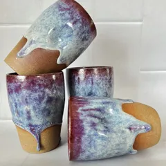 I designed these grip tumblers to fit perfectly in your hand. The beautiful, drippy glaze is a mix of deep purples and blues, making each stoneware cup a unique piece of functional art.