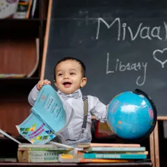 A creative 'Little Scholar' themed milestone shoot. I love bringing imaginative ideas to life, using props like books and a globe to create a fun and memorable scene for your child.