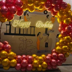 Celebrations for adults should be chic and memorable. For this birthday at The Bier Library in Koramangala, I created a stunning balloon ring with a neon "Happy Birthday" sign, using a rich gold and chrome red color scheme that complemented the venue's unique ambiance.