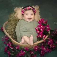 This happy 45-day-old baby is surrounded by vibrant bougainvillea flowers. I love incorporating natural elements to add a pop of color and life to my newborn shoots.