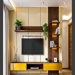 A vibrant and modern TV unit design with a pop of glossy yellow on the lower cabinets. The combination of light beige panels, dark wood fluting, and backlit shelves creates a balanced and energetic look.