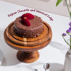 The Belgian Chocolate and Hazelnut Fudge cake, featuring dark chocolate sponge, house-made hazelnut spread, and a glossy rocher glaze. A true obsession for chocolate lovers.