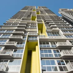 This low-angle shot of the Serein facade highlights the deep balconies and structural details. These elements are not just aesthetic; they provide private outdoor space for residents and contribute to the building's overall passive solar design.