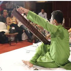 A moment of performance with a Tabla player, set against the backdrop of an engaged audience. Every concert is a three-way conversation between me, my co-artist, and the listeners.