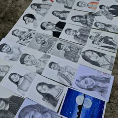 Another view of my recent creations laid out together. You can see the range of portraits, from individual headshots to more creative pieces.