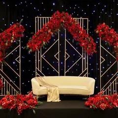 A bold and dramatic stage setup perfect for a themed corporate awards night or gala. The combination of rich red florals, a geometric gold framework, and a starry black backdrop creates a powerful and glamorous statement.