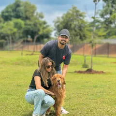 A happy couple posing with their beautiful Golden Retriever. It's the perfect spot for a family photo.