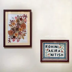 A custom nameplate and a framed pressed-flower artwork displayed together on a wall. This shows how you can pair different types of my art to create a cohesive gallery wall.