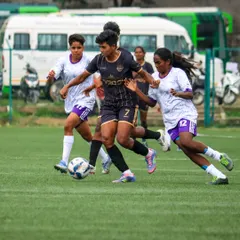 Three players converge on the ball in a tight contest, showcasing the fast-paced action of our 5-a-side girls' football tournaments.