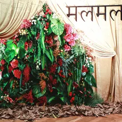 For a brand's festive collection launch, we constructed this mountain of tropical leaves and red ginger flowers. Set against a simple gold curtain, it created a dramatic and on-brand photo moment.