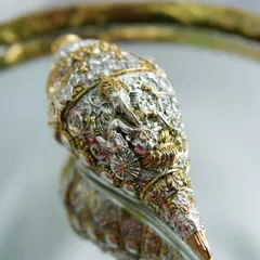 This intricately detailed silver-plated shankh (conch) is an exclusive souvenir. It comes in a gift box, making it a perfect premium gift for an anniversary or housewarming.