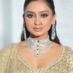 Another close-up, this time focusing on the model's radiant makeup and the intricate details of the gold sequin blouse.
