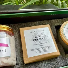 The 'Rose Gift Box,' a perfect token of love for the festive season. This luxurious hamper includes a Rose Whipped Soap, a Rose Pink Clay artisanal bar, and a Rose Soy Candle.