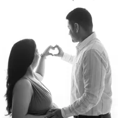 A beautiful black and white silhouette of a couple forming a heart with their hands. The text overlay "Our Love is Growing" adds a sweet touch.