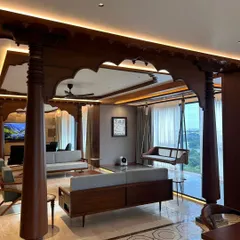 In this Bengaluru apartment, we integrated traditional Indian architectural elements within a contemporary living space. The intricately carved wooden pillars and oonjal (swing) create a focal point, celebrating heritage while maintaining a modern, open-concept feel.