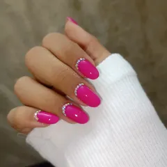 A bright magenta polish with a simple, elegant half-moon of sparkling crystals at the cuticle.