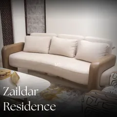 A full view of the sofa we designed for the Zaildar Residence. Draped in a soft, plush fabric with contrasting leather armrests, it strikes the perfect balance between cozy comfort and contemporary style.