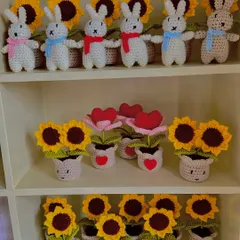 A section of a large order featuring bunny keychains and potted flowers, including sunflowers and heart-shaped blooms.