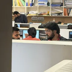 A candid moment of collaboration in our studio. We believe that informal discussions and peer reviews are just as important as formal meetings in refining our design ideas.