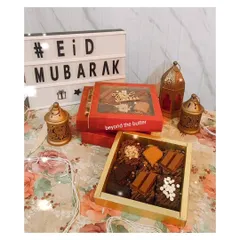 An assortment of my fudgy brownies ready for an Eid celebration. This box includes different toppings like KitKat, Biscoff, and white chocolate chips, offering a little something for everyone.