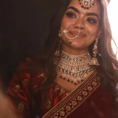 A happy bridal moment captured in our stunning Rajwadi rental lehenga. The detailed jewellery set, also available for rent, perfectly complements the outfit.
