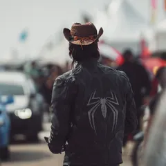 Adrenaline incoming. A shot from behind a participant with a custom jacket, looking out over a sea of performance cars.