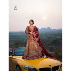 Another angle of the bridal lehenga shoot, emphasizing the grand scale of the outfit and the dramatic cityscape background. The velvet shawl's rich color and texture are highlighted here.