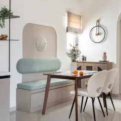 This dining nook from the Rohan Upavan project features a custom-built bench with an arched back and soft mint-green upholstery. It’s a perfect example of how I create stylish and functional solutions for compact spaces.
