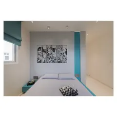 For the kid's room in the Fluted House, I used a palette of muted teal and grey, complemented by monochrome superhero graphics. This approach creates a youthful, contemporary style that is fun and inspiring without being overwhelming.