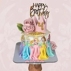 A cake fit for royalty. This Disney Princess cake for a 4th birthday features beautiful fondant drapes in each princess's signature color and is topped with a golden crown.