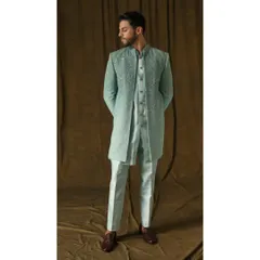 I designed this three-piece sherwani set in a refreshing mint green for a modern yet classic wedding look. The fully embroidered long jacket, paired with a matching inner kurta and trousers, is crafted from premium fabric to ensure both comfort and a commanding presence.