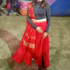 A full-length shot of the client in the red skirt, showing how the dupatta is draped to complete the indo-western look. A great rental option for a fun, festive occasion.