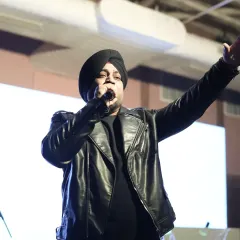 The male vocalist engaging with the crowd during the Sangeet performance.