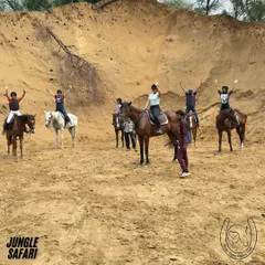 A group of friends celebrates reaching a sandy clearing on their jungle safari. Moments of shared joy and accomplishment like this are what make our group rides so special.