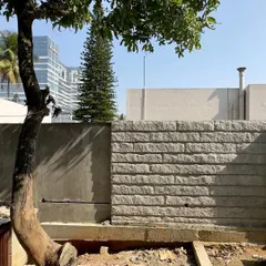 Stone is a geological material, a piece of a mountain. Here, during construction, we see the process of creating a skin for the building, where the texture and weight of the stone begin to define the space.