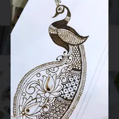 The peacock design is now being filled with intricate details like checks and dots, which adds texture and richness to the overall pattern.