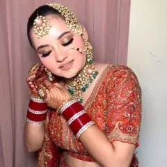 The complete look, with a beautiful smile. Her traditional jewelry, including the passa and nath, adds a regal touch to the entire ensemble.