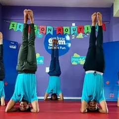 The strength and dedication of our team is on full display. Our instructors perform synchronized headstands, highlighting the level of skill and discipline we bring to our programs.