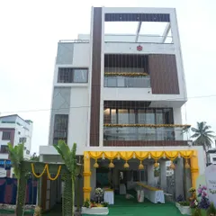 The exterior of a new home decorated for a housewarming celebration. We created a welcoming entrance with a yellow archway, traditional hanging bells, and banana leaf decorations.